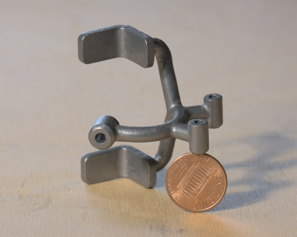 Pen holder attachment  printed in titanium from i.materialise (before hole tapping).